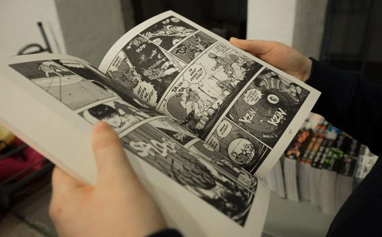 person reading a graphic novel)